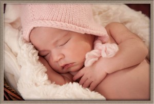 Newborn baby in pink hat