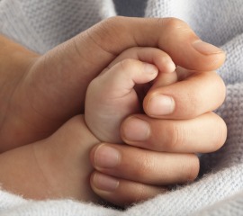 parent-holding-babys-hand
